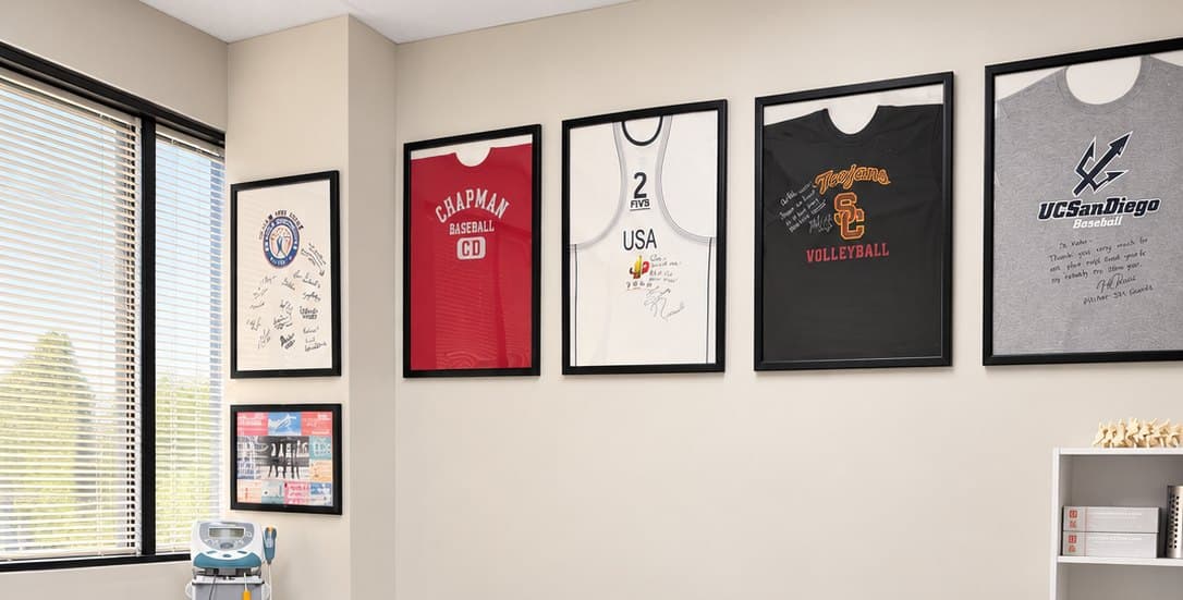 Signed sports jerseys framed on the wall of the KOH Physical Therapy Lab clinic