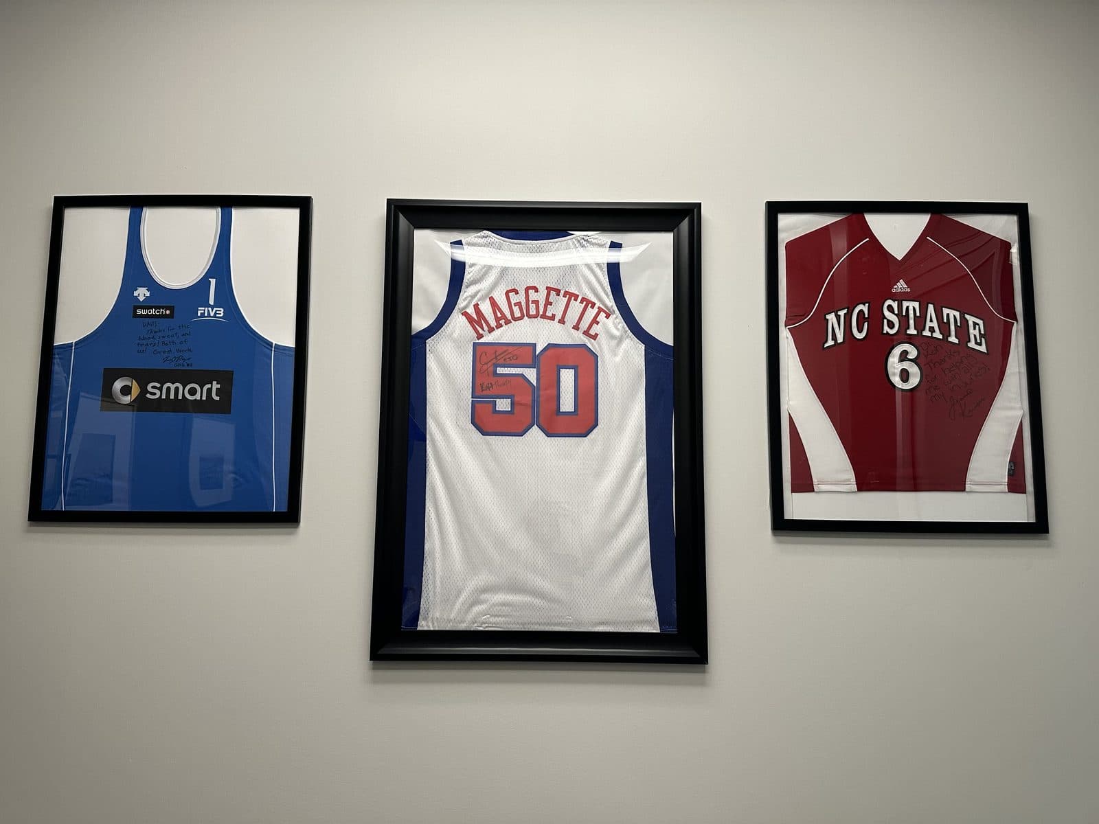 Three framed, signed athlete jerseys on the wall of the KOH Physical Therapy Lab clinic